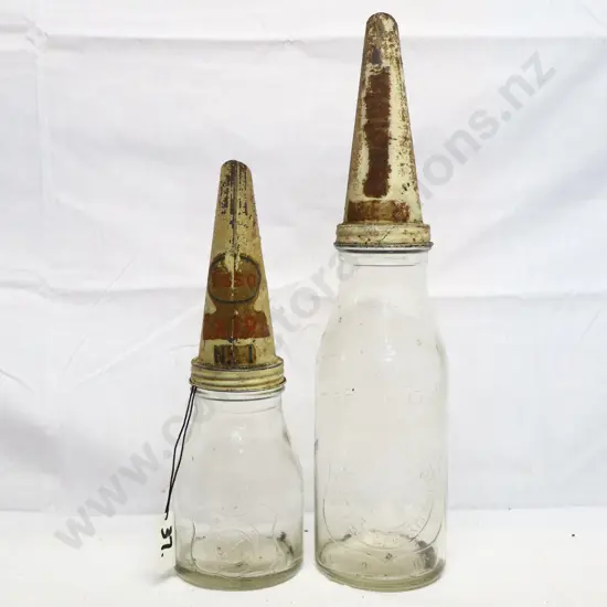 Pair of Antantic Oil Embossed Oil Bottles And Tin Tops